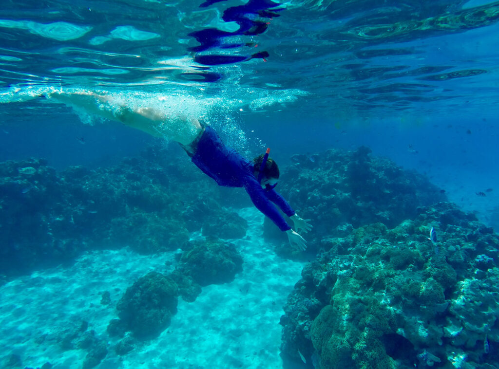 Island Escapes Bora Bora Tahiti Holidays Woman snorkeling at Coral Gardens in Bora Bora French Polynesia