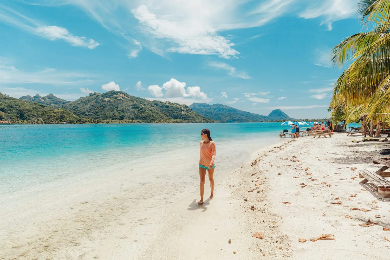 Island Escapes Huahine Tahiti Holidays French Polynesia Travel beach picnic motu tour on Huahine Tahiti French Polynesia Happy tourist woman walking on perfect beach living healthy lifestyl