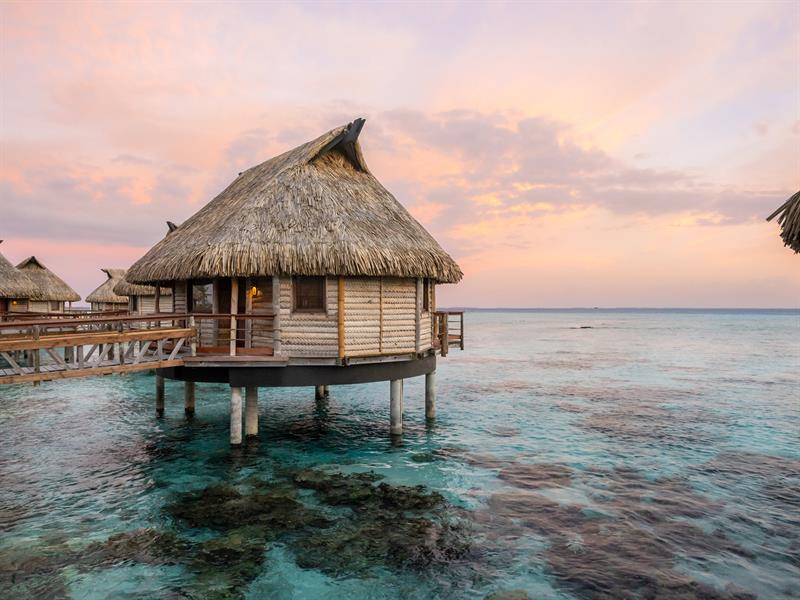 Le Tikehau Overwater Bungalow Exterior Twilight Lagoon Tahiti Resorts Island Escapes