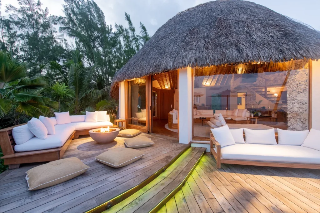 Motu Nao Nao villa exterior thatched roof deck fire bowl eveningTahiti Resorts Island Escapes