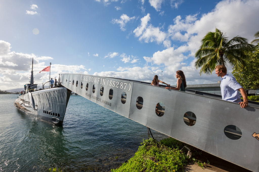 Family walks along USS Bowfin gangway Pearrl Harbor Oahu