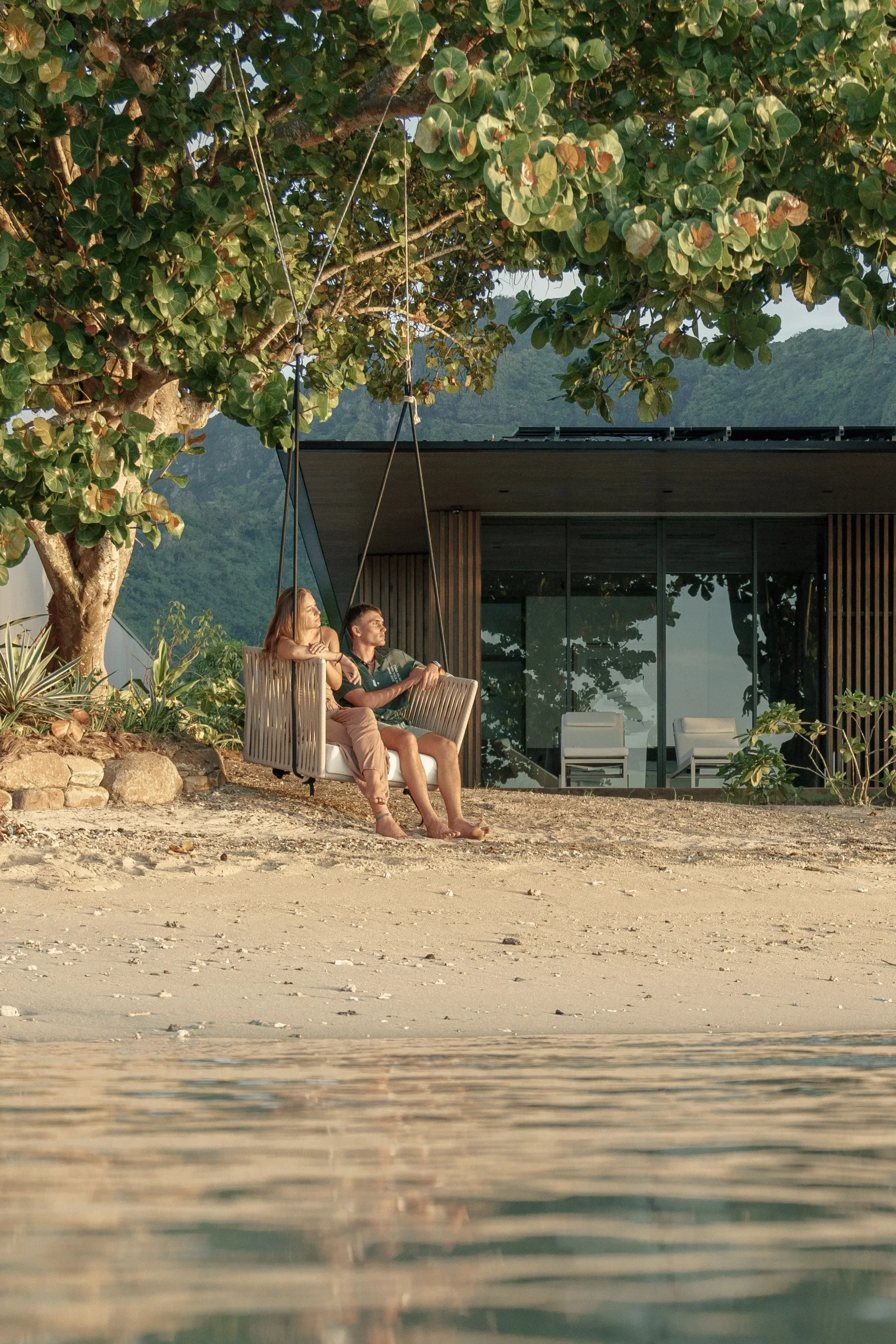 Sunset swing on the beach at 'Oro Paraoa villa estate