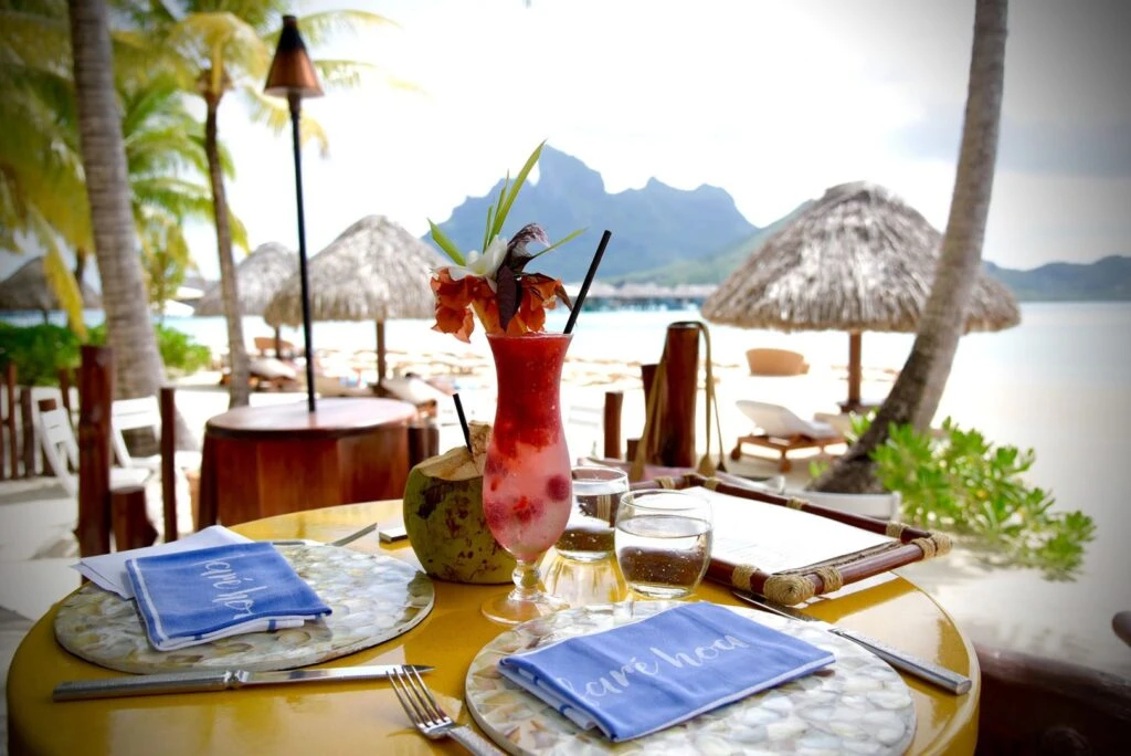 Beachside table at Four Seasons Bora Bora facing the lagoon and Mount Otemanu